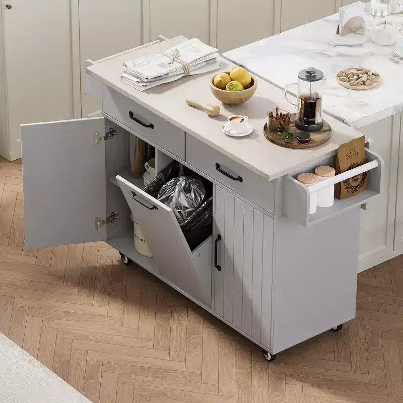 Isla de cocina con armario para guardar el cubo de basura y estante ajustable, carrito de cocina con ruedas y ala abatible, toallero y cajón