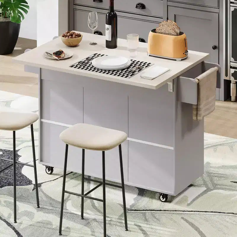 Isla de cocina con armario para guardar el cubo de basura y estante ajustable, carrito de cocina con ruedas y ala abatible, toallero y cajón